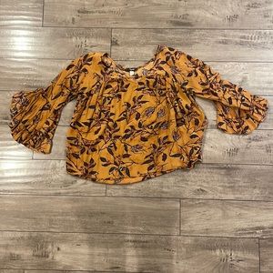 Patterned burnt orange blouse.